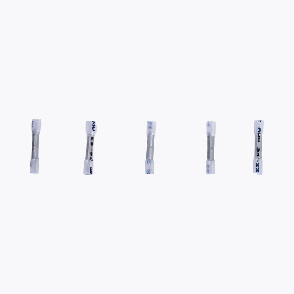 Five Cable Joiner Butt Splice 2mm white (5 Pack) connectors arranged in a row, designed for secure electrical connections in camping power and LED lighting setups.