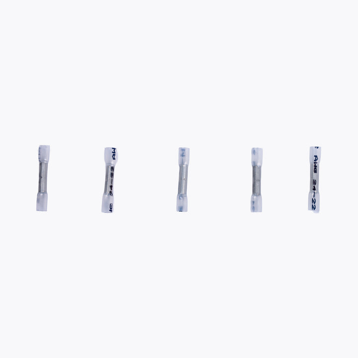 Five Cable Joiner Butt Splice 2mm white (5 Pack) connectors arranged in a row, designed for secure electrical connections in camping power and LED lighting setups.