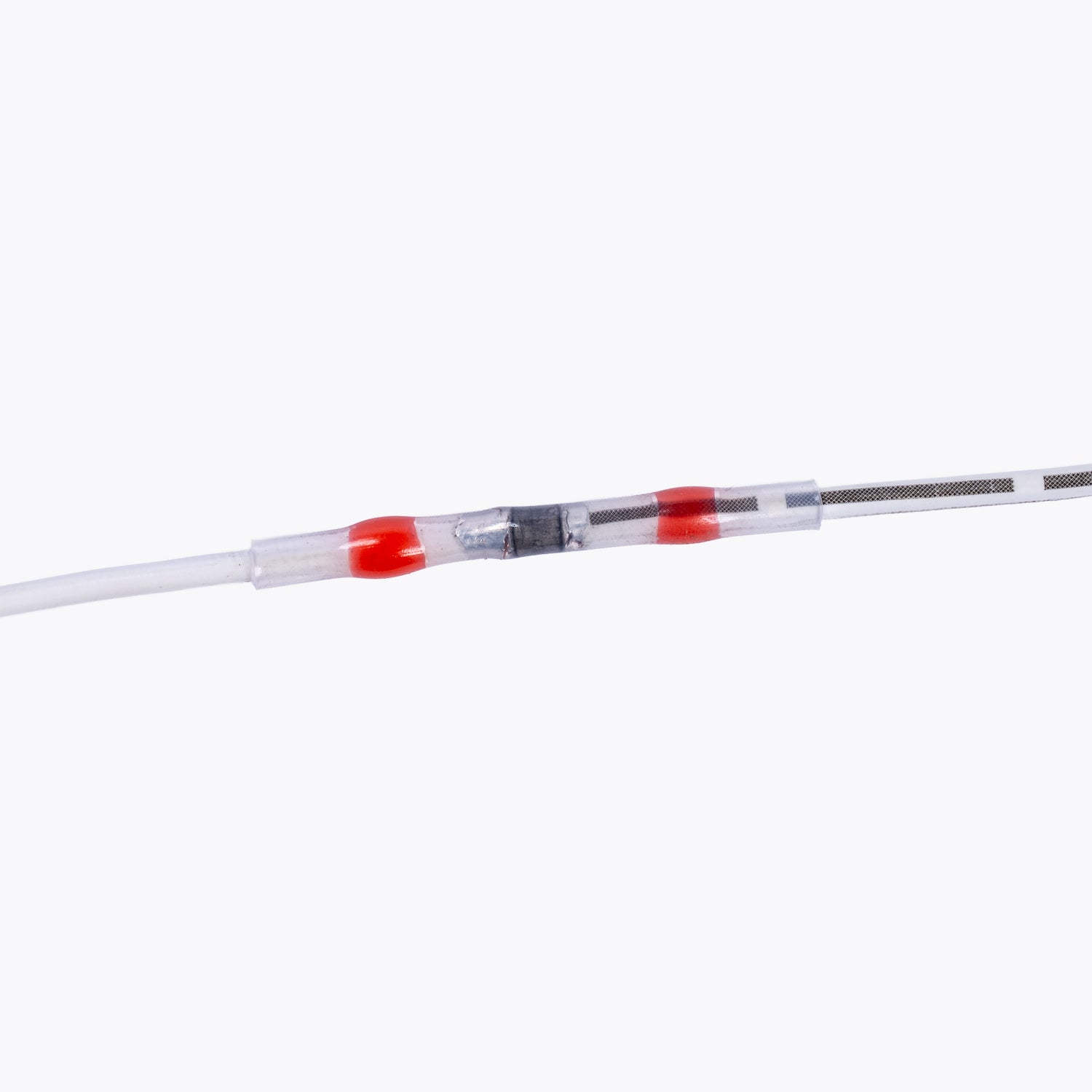 Close-up of a soldered wire connection using the Solder Sleeve Kit - 1.6-2.7mm Red (5 pack), demonstrating secure electrical insulation for camping power and LED lighting solutions.